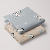 Folded 2-pack of baby muslin swaddles in Dalmatian and Dog Park prints